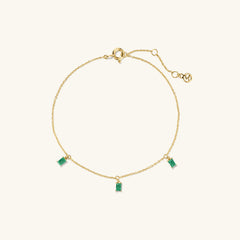 Baguette Gemstone Bracelet: A gold chain bracelet adorned with rectangular green gemstones, perfect for stacking and adding elegance to your accessory collection.