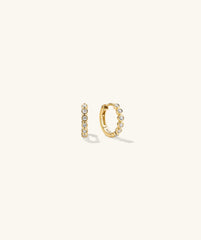 Bezel Lab Grown Diamond Huggies: A pair of 14k solid gold earrings featuring bezel-set lab grown diamonds, showcasing elegance and ethical craftsmanship.