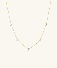Multi Station Diamond Necklace: A 14k gold choker featuring five diamonds, blending dainty and edgy elements for a striking look.