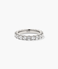 Aurora Lab Grown Sapphire Eternity Ring showcasing sparkling diamonds and sapphires set in a sleek platinum band, highlighted in a close-up view.