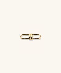 Mejuri Custom Chain Enhancer featuring a gold metal clasp with a black center, and a gold chain with several rings.