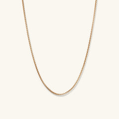 Round Box Chain Necklace featuring a sleek gold chain with a small diamond pendant, perfect for everyday wear and pairing with matching bracelet.