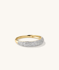 Pavé Diamond Thin Dôme Ring: A close-up of a gold and silver ring adorned with multiple diamonds, showcasing its intricate craftsmanship and luxurious design.