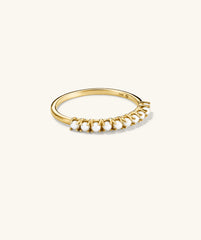 Pearl Half Eternity Ring: A close-up of a gold ring featuring a handcrafted stack of pearls set in recycled 14k solid gold, showcasing elegant craftsmanship.