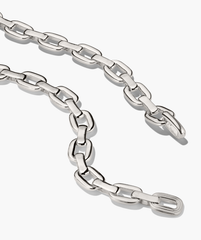 Stevie Chain: Polished silver-tone necklace with interlocking elongated oval links, featuring a single textured link for added interest, laid against a white background.