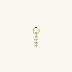 Close-up of the Single Diamond Icicle Hoop Charm, featuring a gold pendant designed to enhance everyday hoops with a touch of elegance.