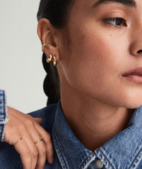 Woman wearing a denim jacket and Bold Small Hoops, with a close-up highlighting the earrings.