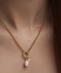 Woman wearing Organic Pearl Charm necklace with a pearl and diamond pendant.