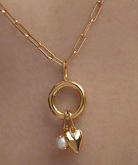 Gold Heart Charm pendant with a pearl, featured on a chain, symbolizing love. Ideal for necklaces or bracelets.