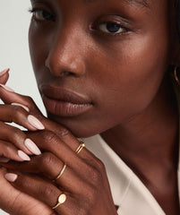 Diamonds Line Ring with six diamonds in a prong setting, worn by a woman. The ring is showcased in a close-up shot of her hand.