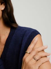 Woman wearing a Prism Lab Grown Diamond Eternity Band on her finger, showcasing the elegant cushy bezel setting of lab grown diamonds.