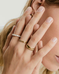 Aurora Lab Grown Sapphire Eternity Ring on a woman's hand, showcasing the elegant arrangement of sapphires encircling the solid band.