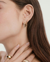 Close-up of the Ella Double Hoop earrings featuring a thin hoop and a striking lab-grown sapphire hoop with various gemstone cuts.
