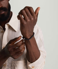 Man wearing the 6mm Gemstone Beaded Bracelet, featuring a close-up of his hand showcasing the handcrafted sterling silver beads with a swivel clasp.