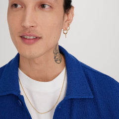 Man wearing a gold Round Box Chain Necklace and a tattoo on his neck, highlighting the necklace's simplicity and everyday wearability.