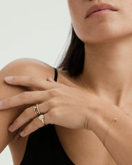 Close-up of a woman's hand showcasing the Pavé Diamond Signet Pinky Ring, highlighting its intricate diamond detailing and elegant design.