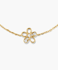 Fleurette Bracelet with a gold chain and a four-petal flower pendant, featuring pavé-set diamonds on petals and center, showcasing elegant, modern design.