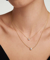 Bezel Lab Grown Diamond Necklace worn by a woman, showcasing a close-up of the necklace on her neck and chest.