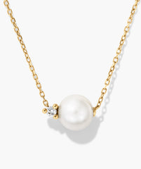 Amelie Necklace featuring a yellow-gold chain with a white freshwater pearl and a small, brilliant-cut diamond accent, showcasing elegance and refined design.