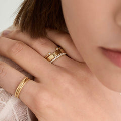 Close-up of a woman's hand wearing the 4mm Smooth Band, a lightweight and lasting gold ring, showcasing its elegant design and craftsmanship.