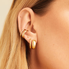 Close-up of a woman's ear wearing the Duet Ear Cuff, a handcrafted gold vermeil accessory designed for a multi-pierced look without additional piercings.