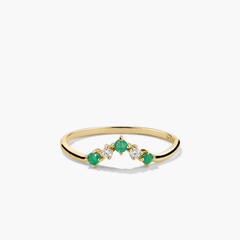 Emerald and Diamond Wishbone Ring: 14k gold ring with three stones, featuring emerald gemstones and responsibly sourced diamonds, showcased in a close-up view.