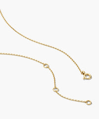 Two of Hearts Necklace featuring a fine yellow-gold chain with adjustable loops, showcasing a unique half-bezel, half-prong sapphire heart pendant.