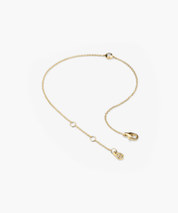 Solo Diamond Bracelet: A solid gold chain featuring small circles and a bezel-set round cut diamond, accented with a secure clasp.