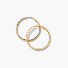 Bold Large Hoops: Handcrafted in recycled 14k solid gold, these statement earrings elevate any outfit with their classic, mood-boosting design.