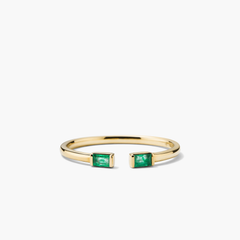 Baguette Emerald Open Ring: A close-up of a gold ring featuring handcrafted emerald baguettes with unique inclusions, highlighting its intricate design and responsibly sourced gemstones.