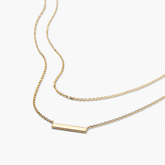 Layered Bar Necklace featuring a gold rectangular bar pendant on a delicate chain, perfect for everyday wear and versatile styling.