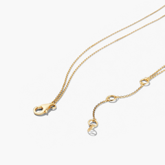 Layered Opal Necklace featuring two gold chains seamlessly bound with a natural opal pendant, showcasing intricate links and a polished finish.