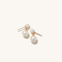 Essential Pearl Earrings: A pair of handcrafted 14k solid gold earrings featuring lustrous pearls, designed to add elegance to any outfit.