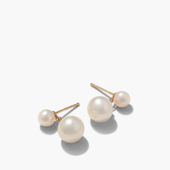 Essential Pearl Earrings, a pair of handcrafted 14k solid gold earrings featuring lustrous pearls in three finishes, showcased in a detailed close-up.