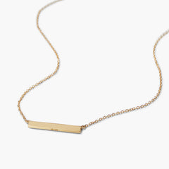 Engravable Bar Necklace with a slim 14k gold bar pendant on a delicate chain, photographed on a white background. Ideal for personalizing with names or dates.