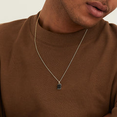 Man wearing a Black Onyx Pendant Necklace, showcasing the elegant design with a strong touch of onyx as a fashion accessory.