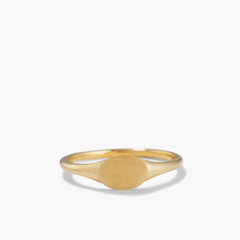 Signet Ring: A close-up of a 14k solid gold ring with a circular bezel, perfect for engraving an initial.