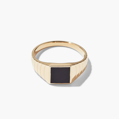 Black Onyx Square Signet Ring: A gold ring featuring a prominent black square centerpiece, offering a bold and elegant fashion statement.