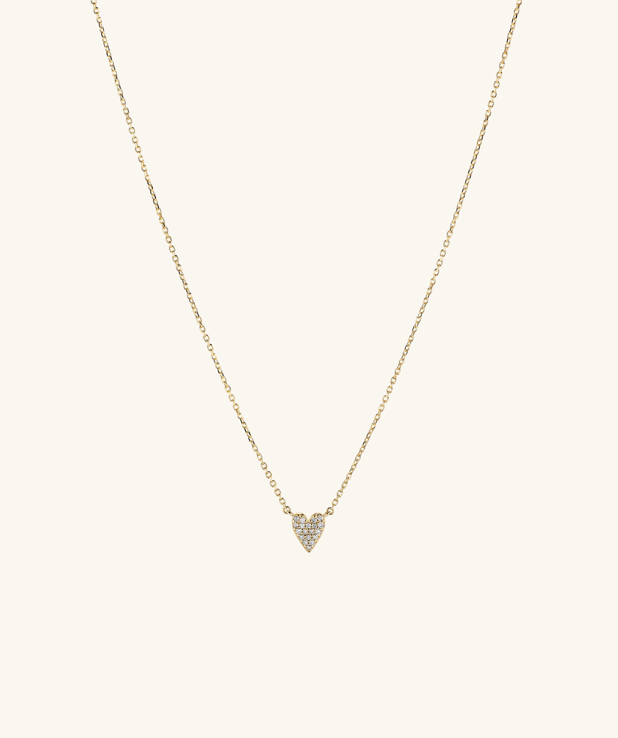 Mini Heart PavÃ© Diamond Necklace featuring a gold chain and a heart-shaped pendant encrusted with diamonds.