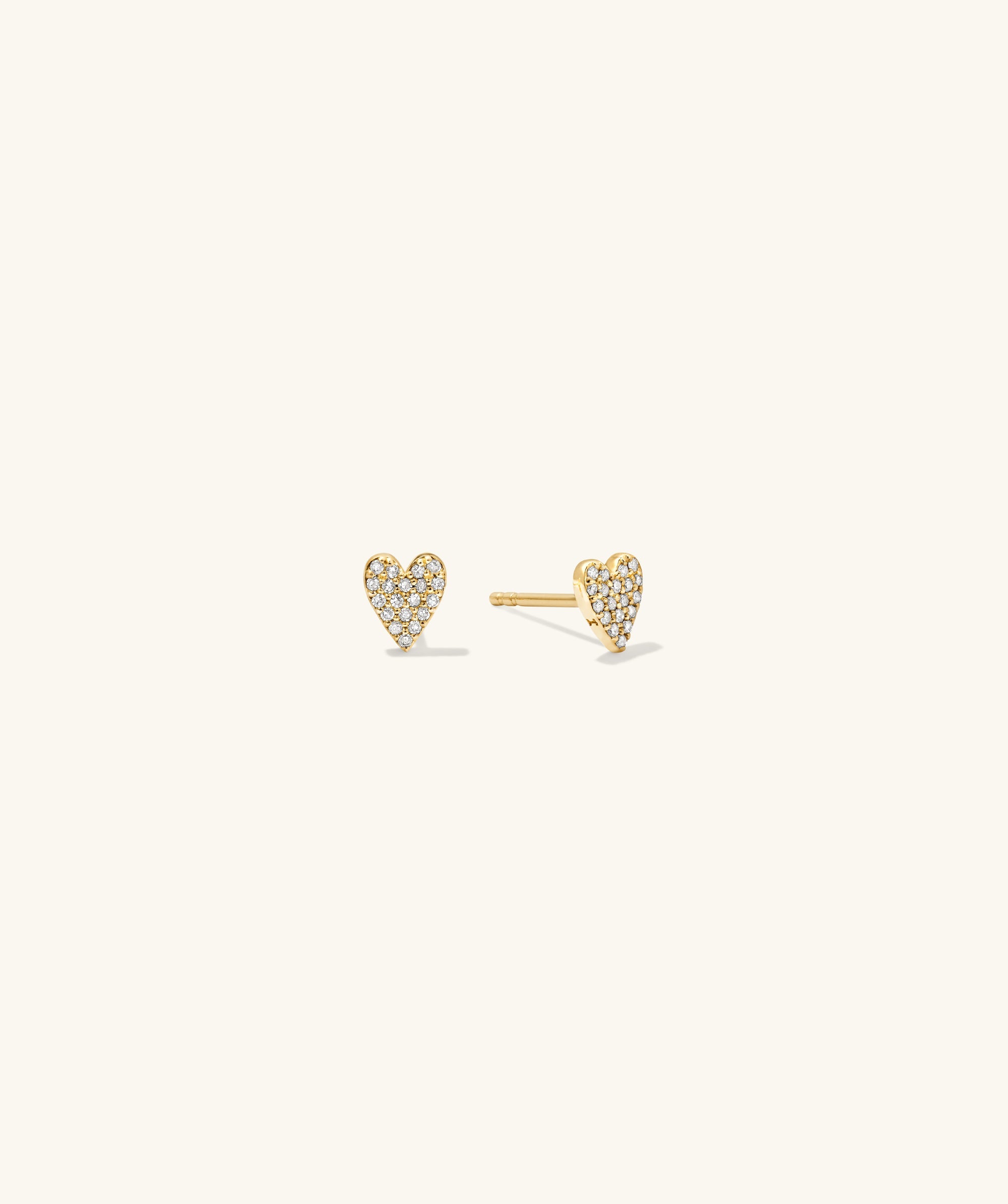 Mini Heart PavÃ© Diamond Stud Earrings: A pair of 14k solid gold heart-shaped earrings adorned with pavÃ© diamonds. Handcrafted, playful, and elegant statement pieces.