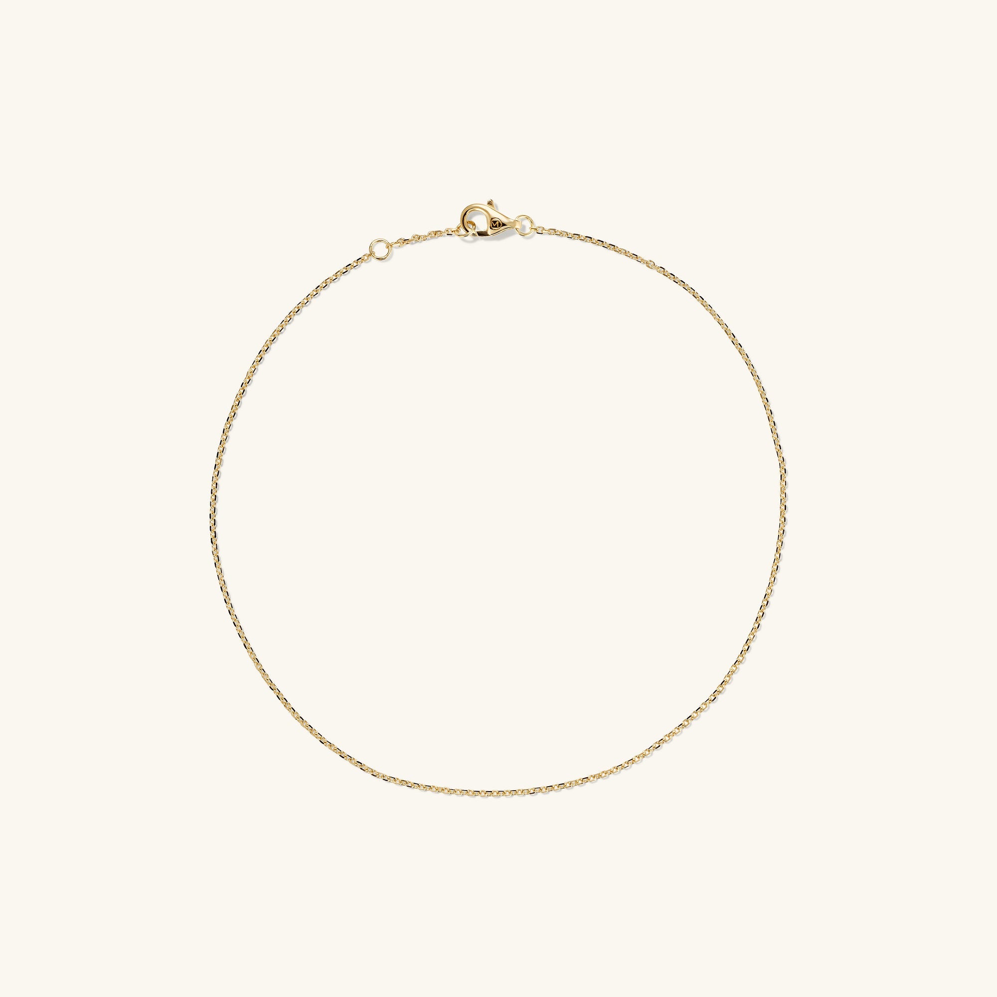 Chain Anklet: A 14k solid gold anklet featuring interlocking links and a secure clasp, handcrafted for a stylish accent to your favorite shoes.