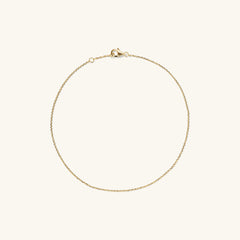 Chain Anklet: A 14k solid gold anklet featuring interlocking links and a secure clasp, handcrafted for a stylish accent to your favorite shoes.