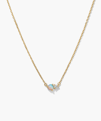 Beverly Necklace: A minimalist gold-tone chain with a central pendant featuring a round opal and clear faceted gem, ideal for layering or wearing solo.