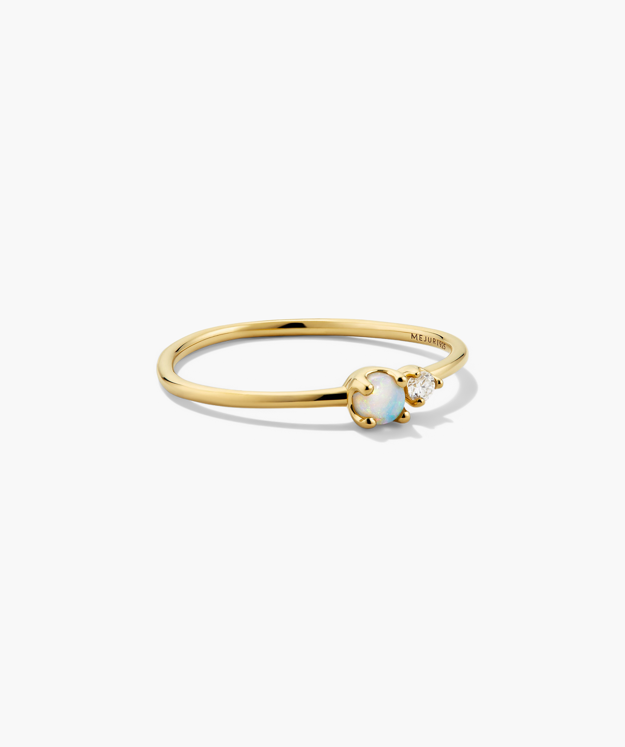 Beverly Ring: A minimalist gold band with a round opal and a tiny clear gemstone, perfect for stacking or wearing solo.