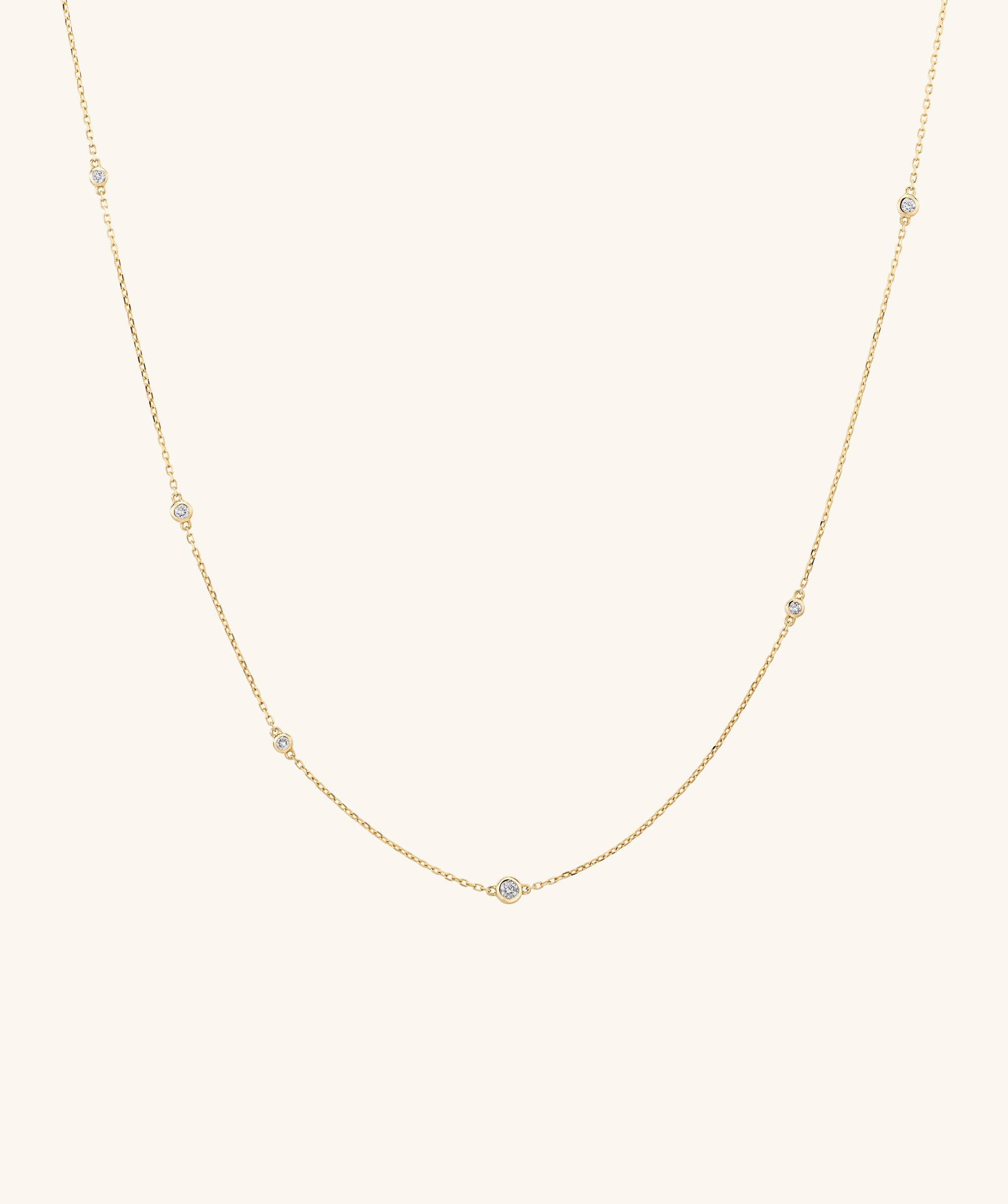 Multi Station Round Diamond Necklace featuring six round bezel set diamonds on a diamond cut cable chain, showcasing maximum shine from every angle.