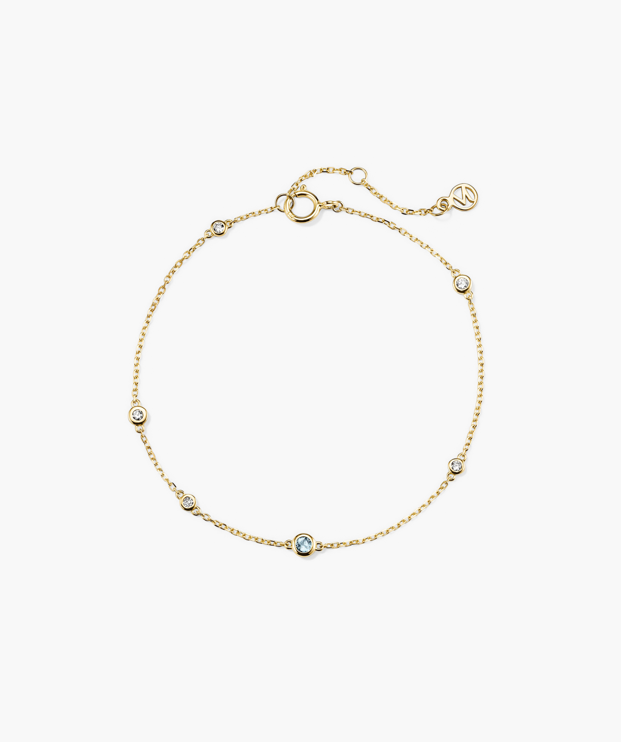 Multi Gemstone Station Bracelet: A 14k gold bracelet adorned with diamonds and a blue gem, showcasing handcrafted elegance and vibrant color.