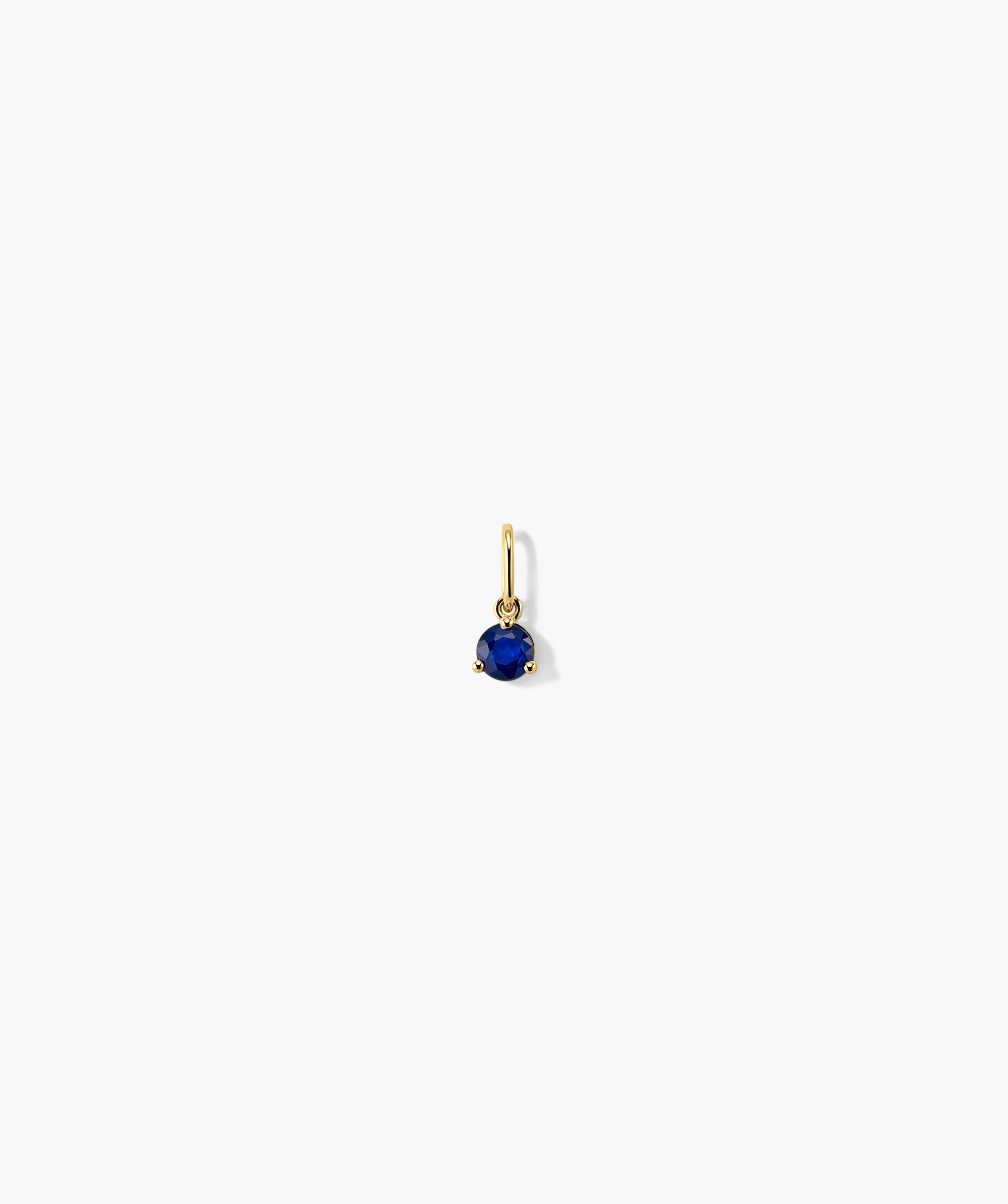 Birthstone Charm: 14k gold earring featuring a prominent blue gemstone, intricately handcrafted for a timeless, elegant look. Ideal for birthday gifts or special occasions.