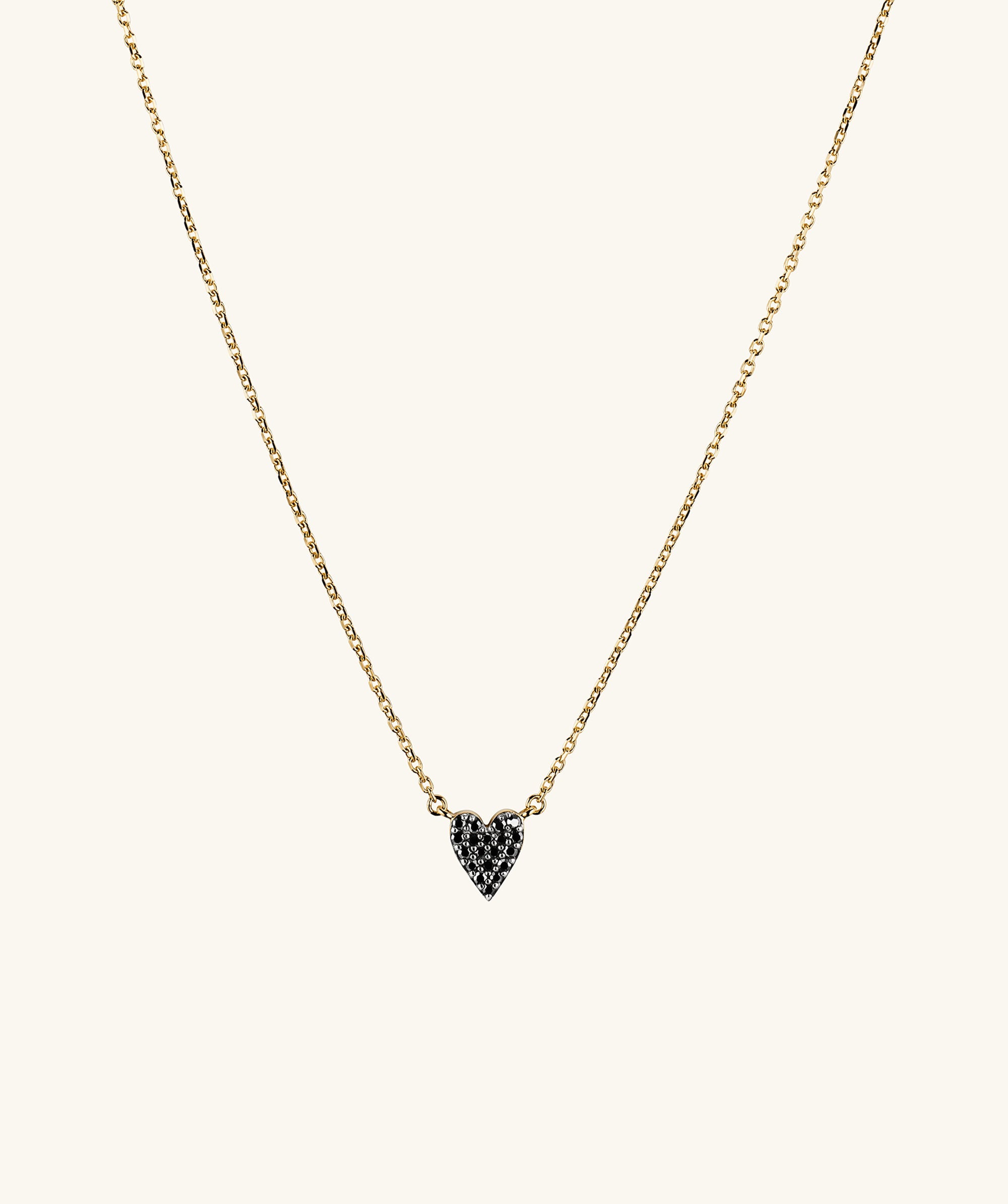 Mini Heart PavÃ© Diamond Necklace featuring a gold chain with a heart-shaped pendant adorned with pavÃ© diamonds, showcasing elegance and sophistication.
