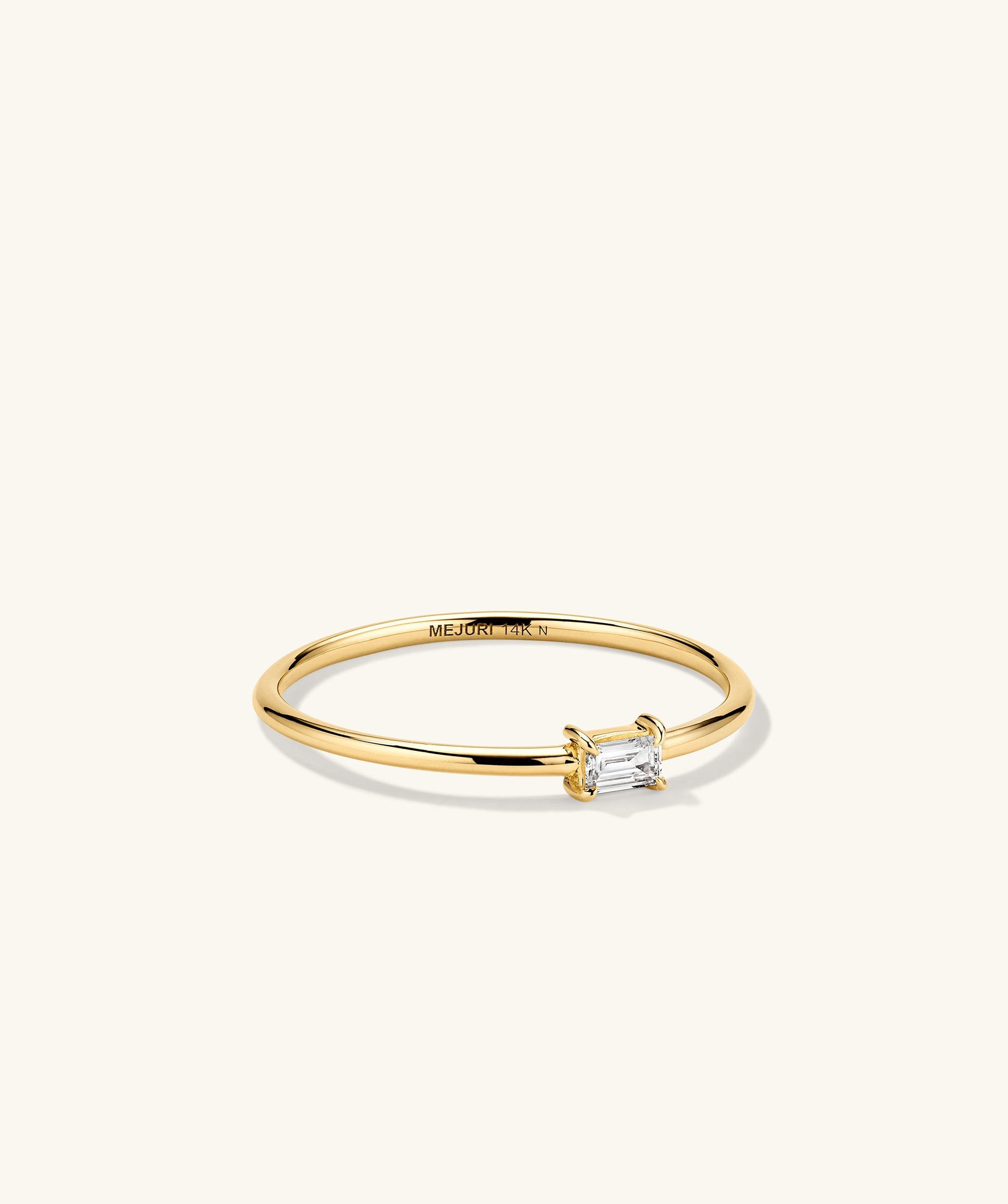 Baguette Stacker Ring featuring a gold band and a central diamond. Ideal as a fashion accessory or engagement ring, showcasing elegant craftsmanship.