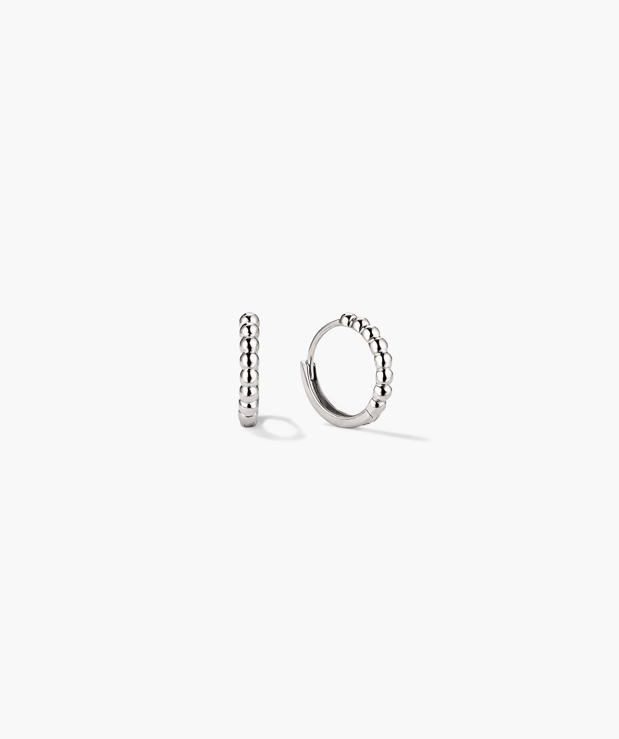 Beaded Huggie Hoops - close-up of a pair of handcrafted silver hoop earrings with beaded detailing, formerly known as the Beaded Hoops.